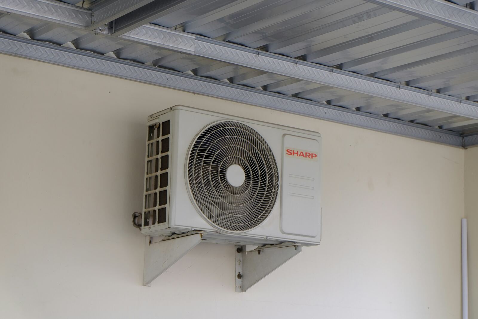 A modern air source heat pump installed neatly outside a contemporary Irish home.